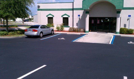 Parking-lot seal and stripe handicap space